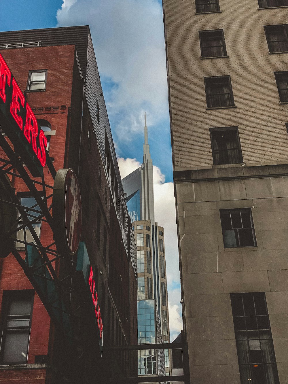 a tall building with a neon sign on the side of it