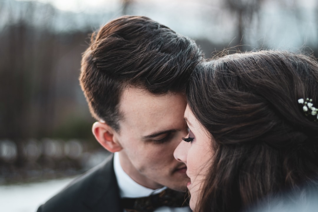 man kissing woman during daytime