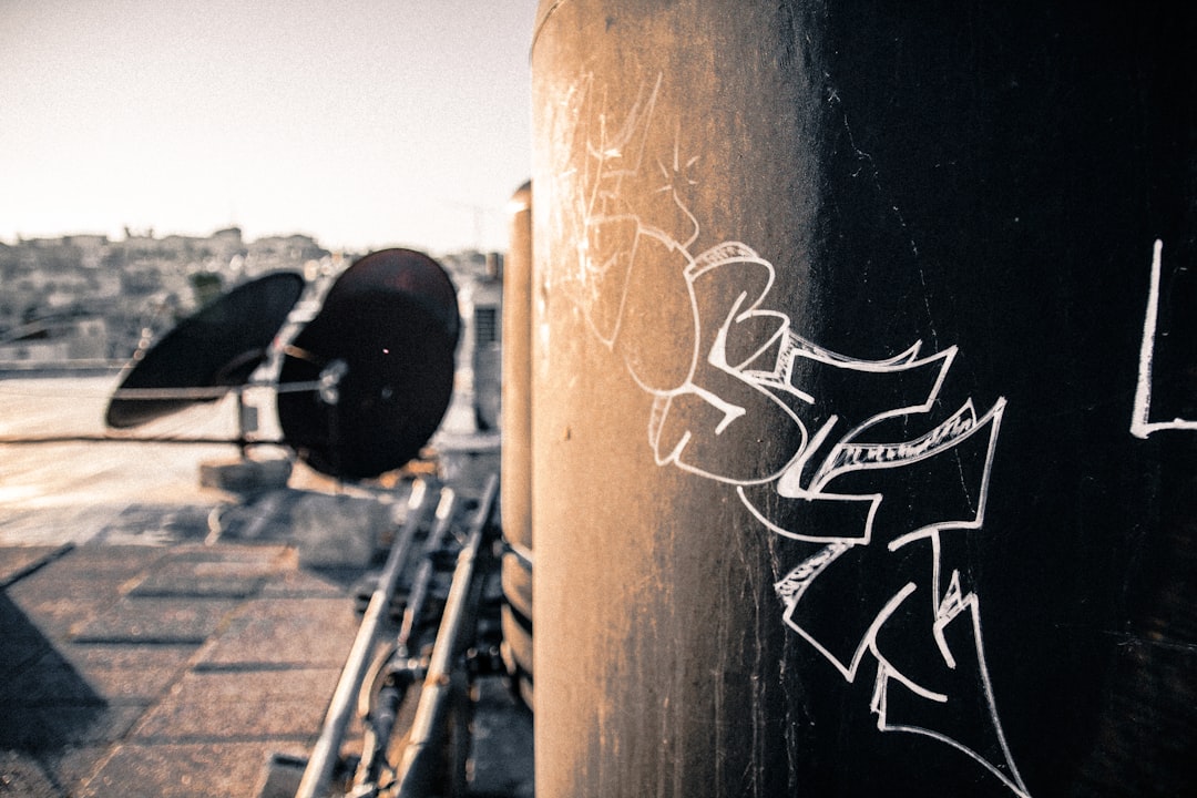 close-up photo of graffiti on grey wall during sunrise