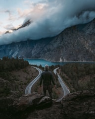 A person standing at a crossroads, contemplating different paths ahead.