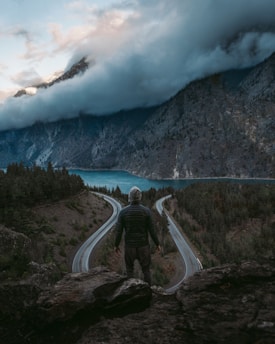 A person standing at a crossroads, contemplating different paths ahead.