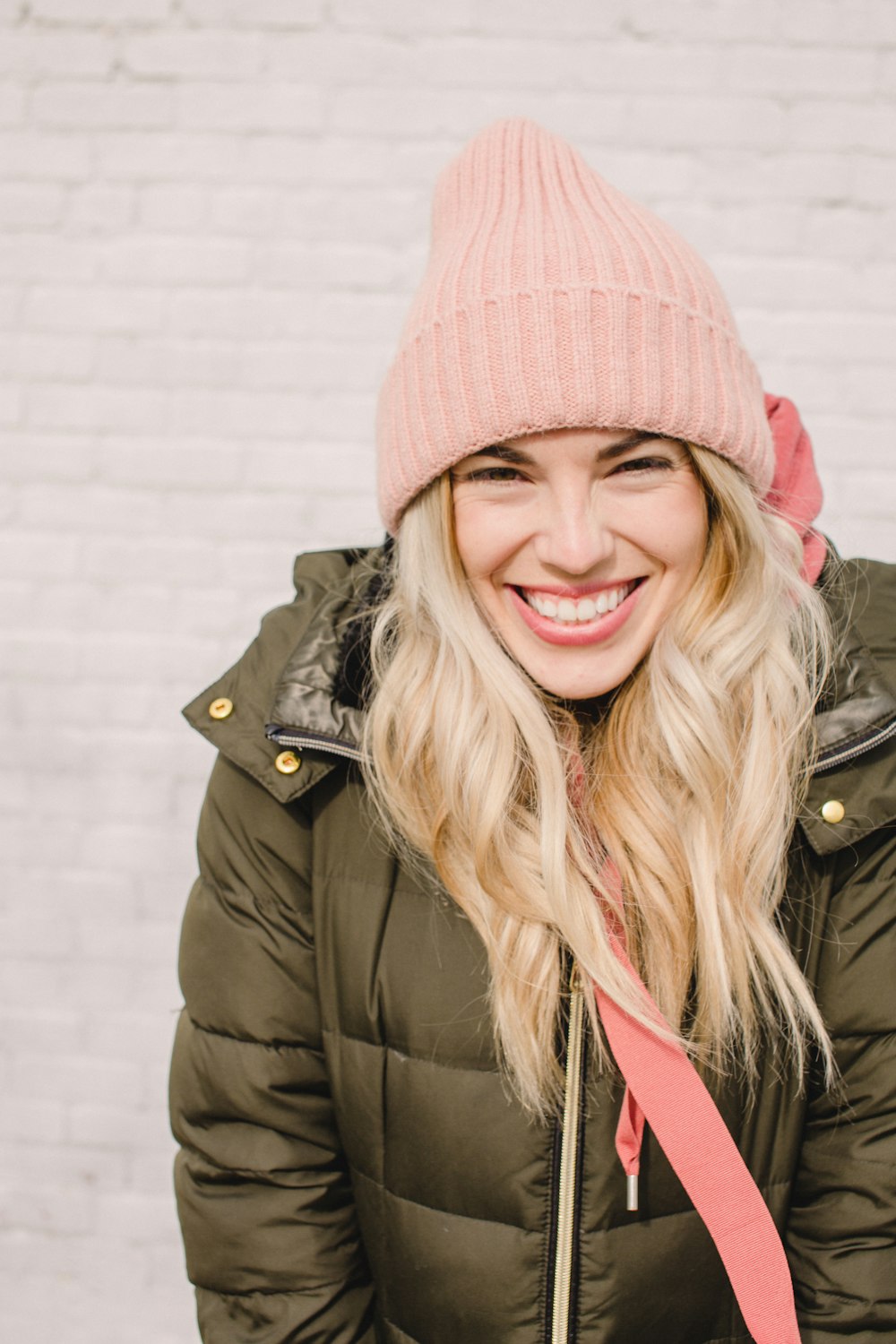 woman in gray bubble jacket smiling