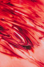 A vibrant swirl of pink and red hues blending like a sunset over an artistic cityscape, evoking energy and connection.