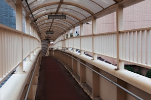 Covered parking area with transparent polycarbonate awnings letting in natural light.