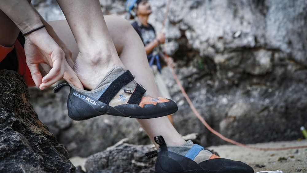 close-up photography of person wearing hiking shoes