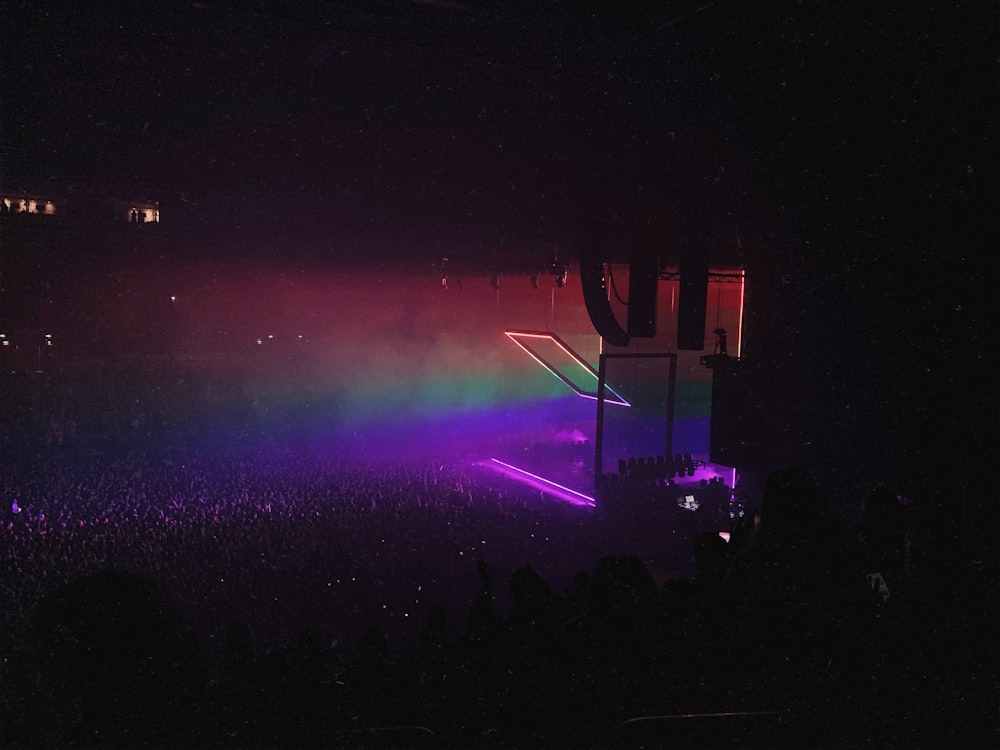 a crowd of people watching a concert at night