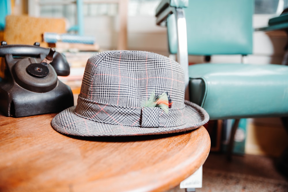 gray fedora hat on table