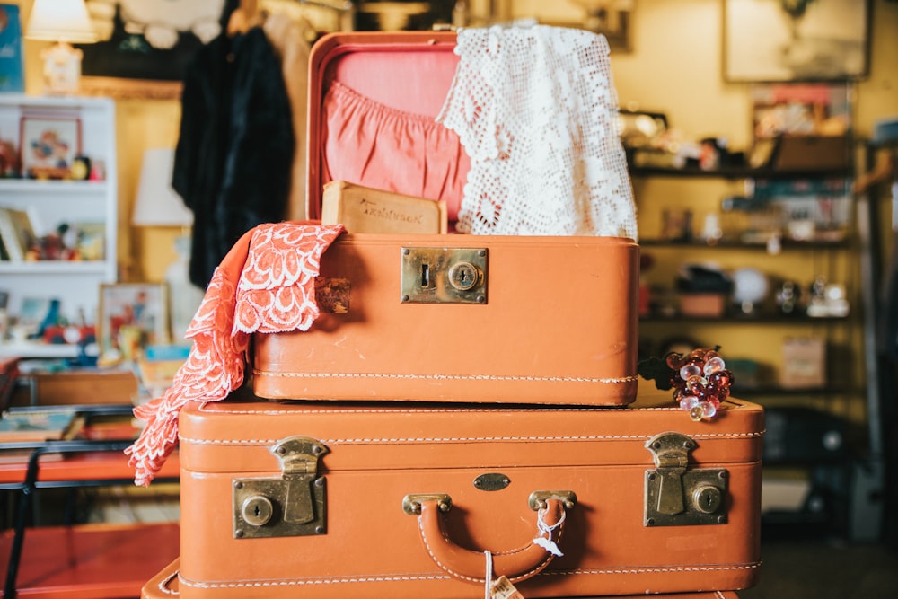 mini brown opened suit case on large suit case