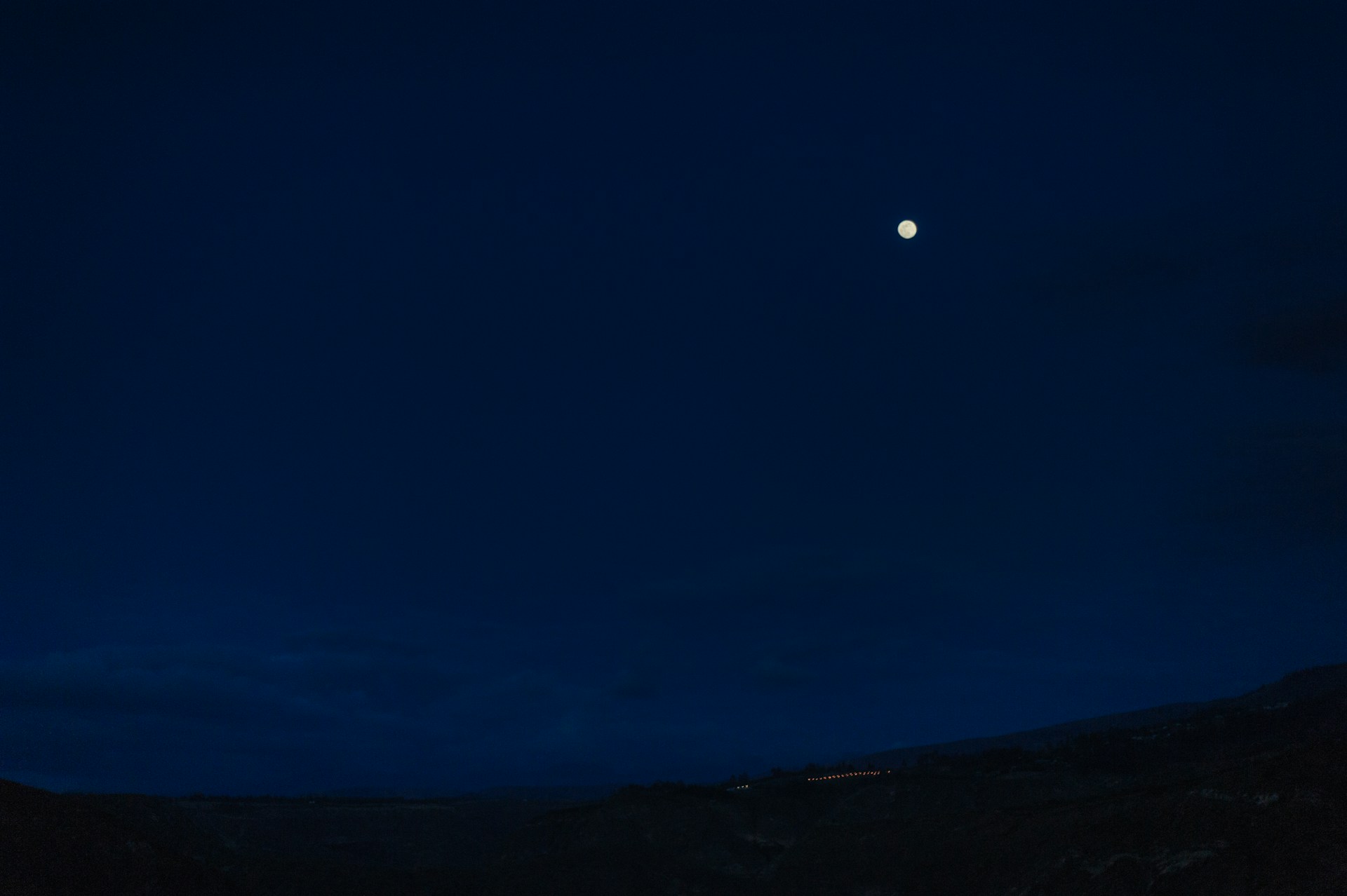A serene moonlit night sky with subtle phases of the moon arcing across, blending into a soft light academia background.