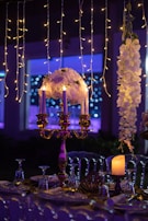 A beautifully decorated event table with flowers and candles.