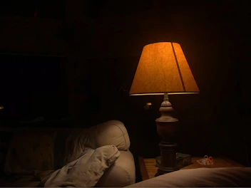 Warm bedside lamp casting gentle light in cozy suite