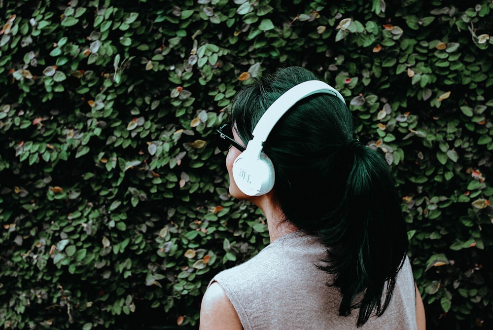 person using white headphones