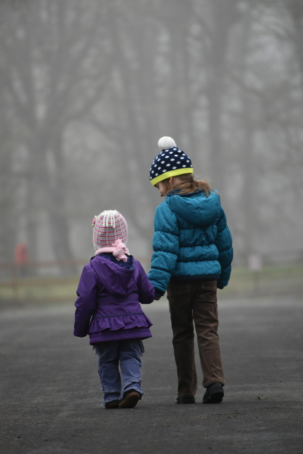 shallow focus photo of girl walking near trees