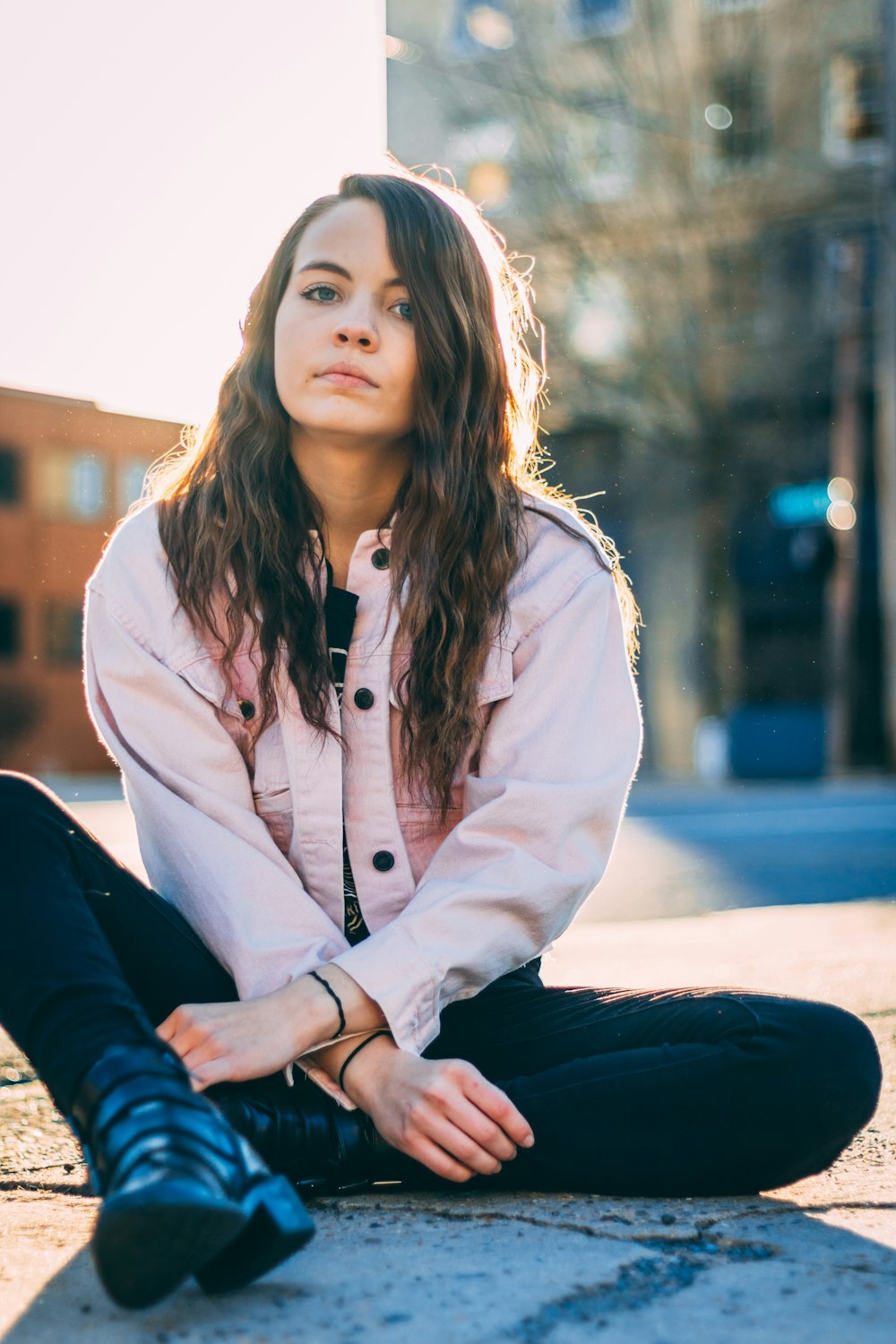 woman sitting on gray floor near the building outdoor