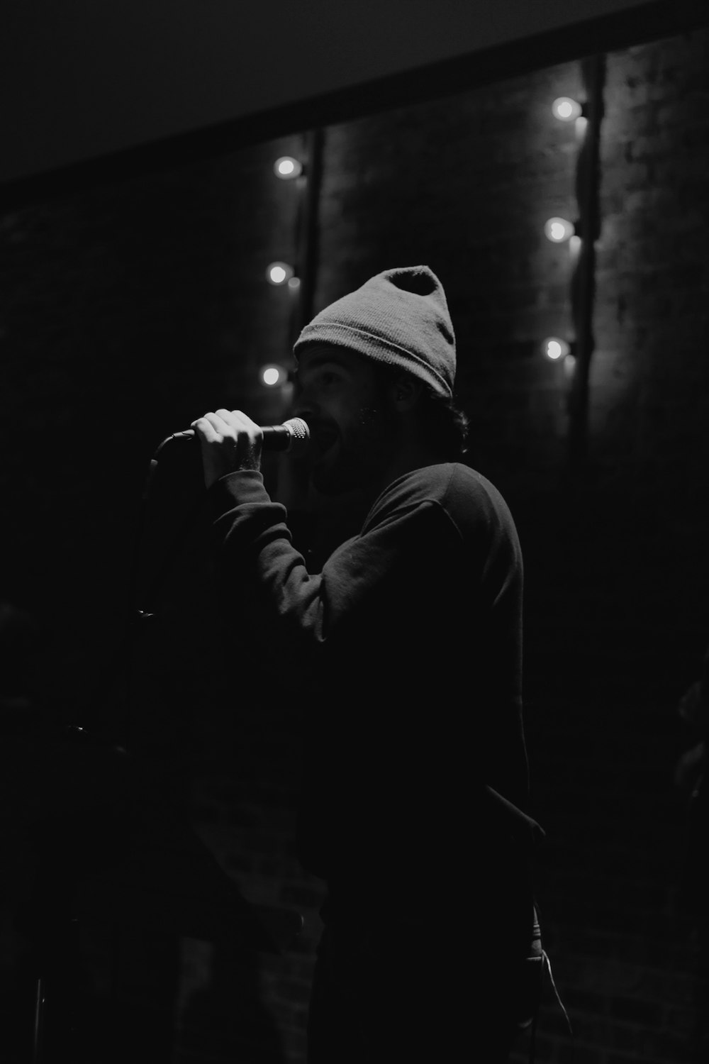 grayscale photo of person singing