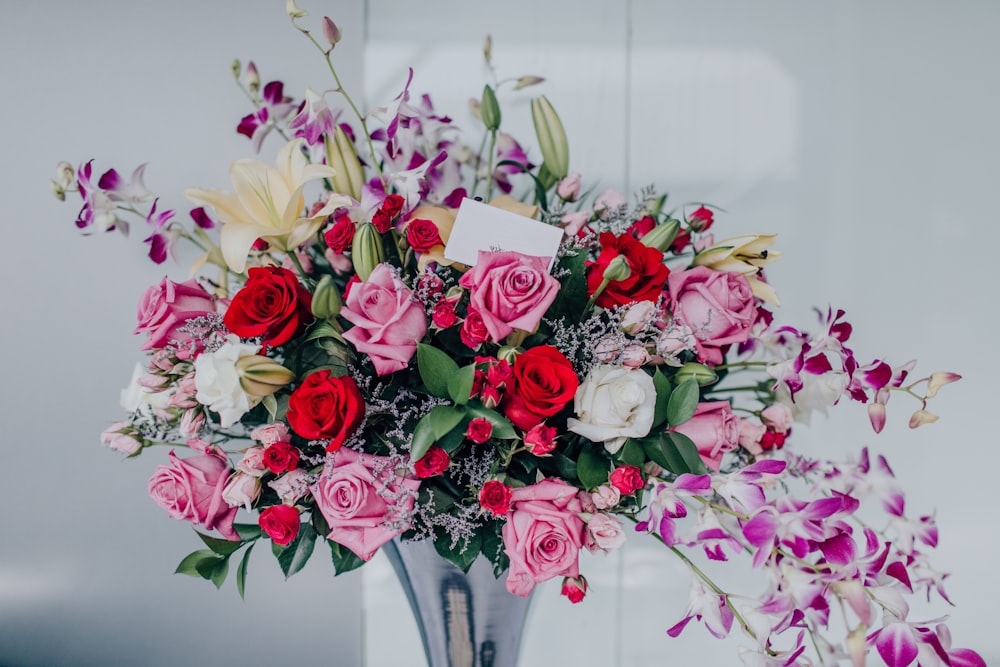 assorted-colored rose flower arrangement