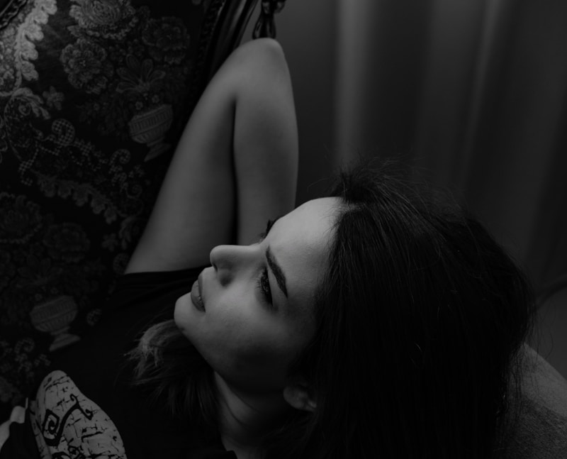 woman lying near curtain