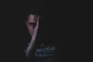 a person smiling on the outside but with a shadowed face hinting at hidden feelings