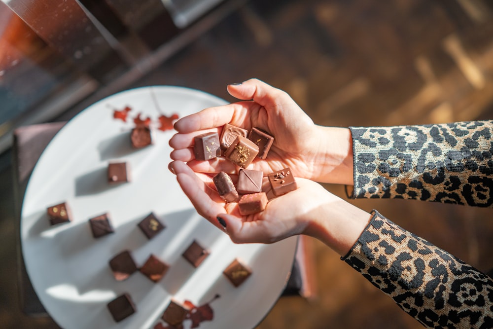 person holding chocolates at daytime