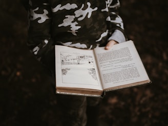 person holds book