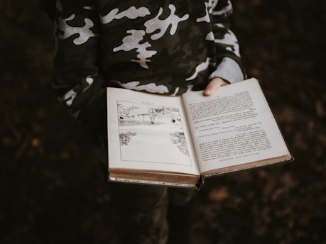 person holds book