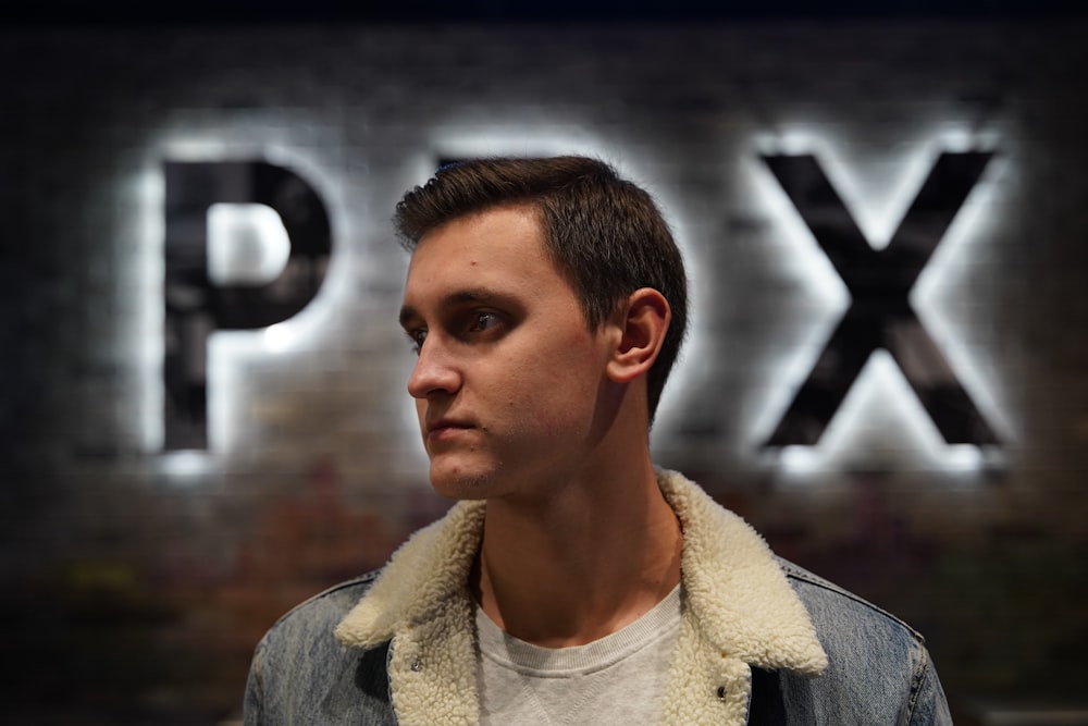 man wearing blue and white denim collard top close-up photo