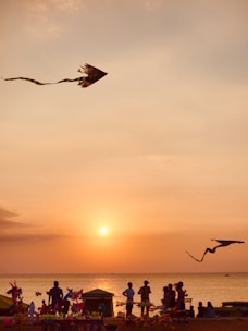A vibrant Balinese beach scene at sunset with tourists enjoying water sports and cultural tours