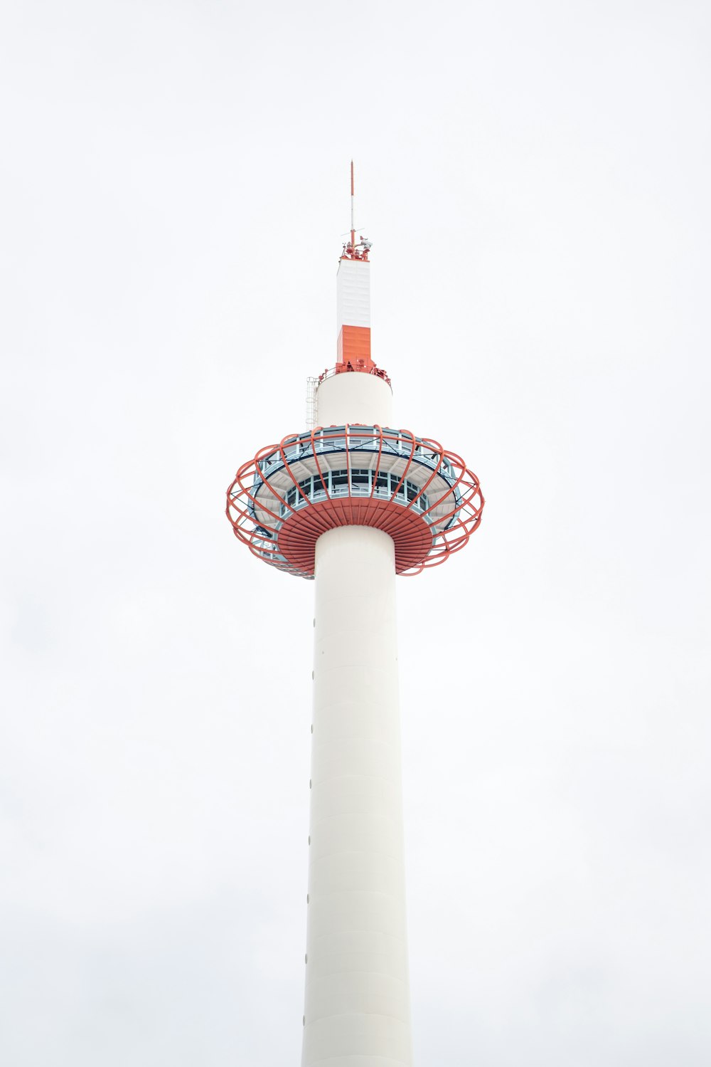 low-angle photography of white and red tower