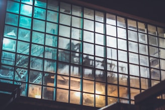 Finished iron windows and furniture lined up, reflecting the subtle glow of factory lights during the late shift.