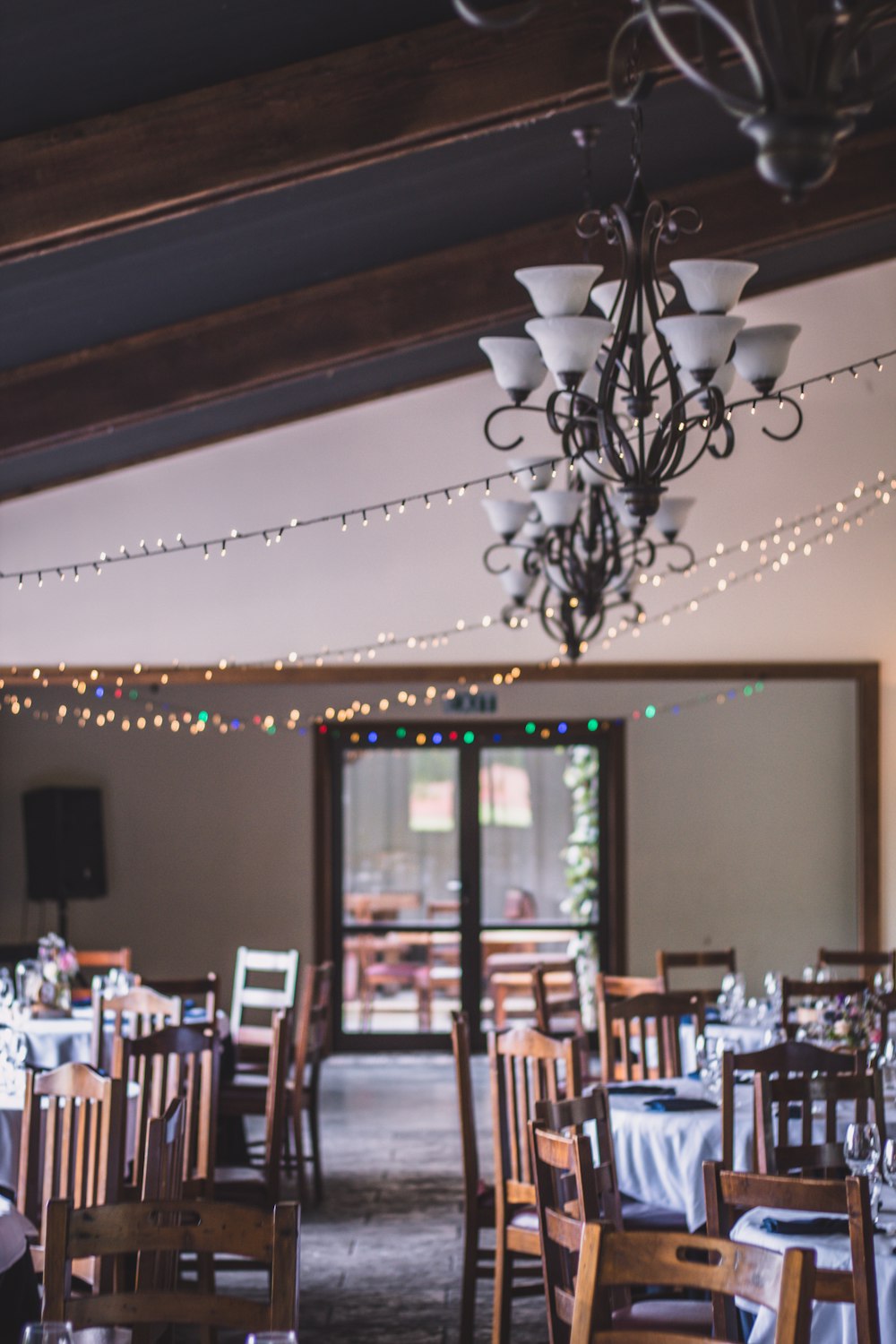 string lights over tables and chairs