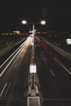 Nighttime shot of illuminated bridges and highways highlighting engineering excellence.