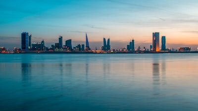 skyscraper view from body of water bahrain teams background
