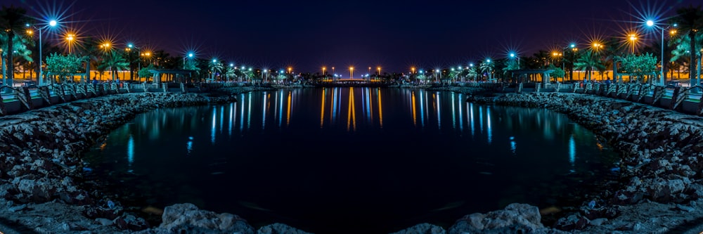 calm water front of street lights at night