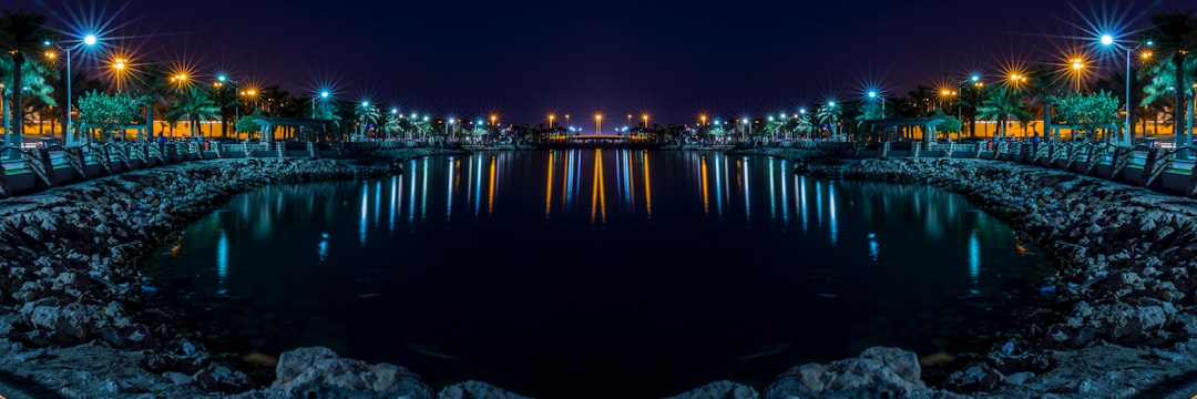 calm water front of street lights at night,