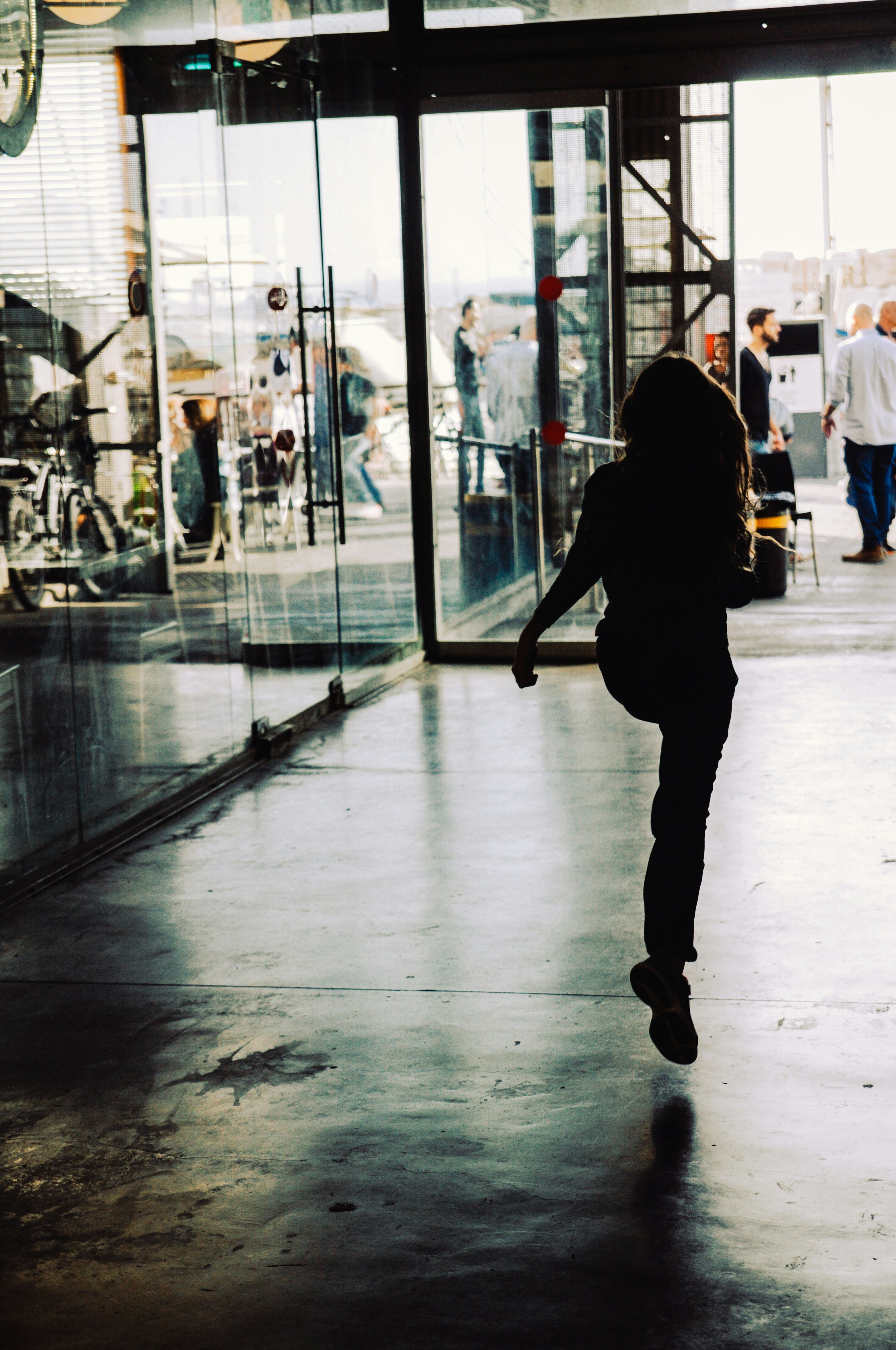 Woman Walking Through Glass Door Photo Free Person Image