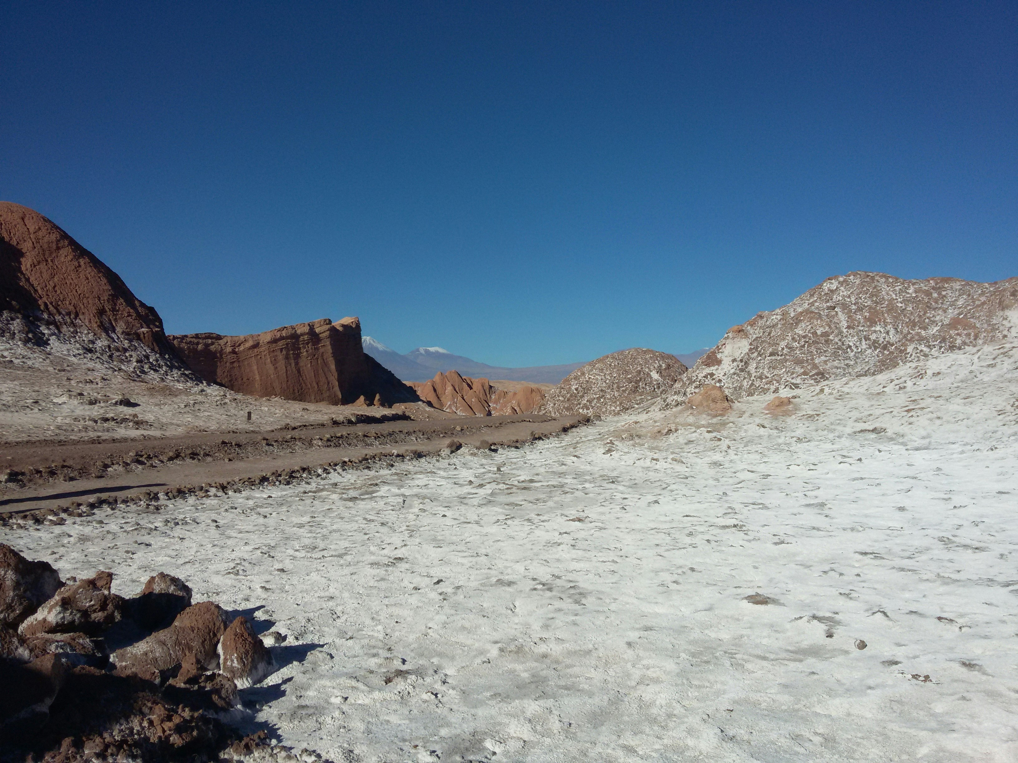 brown field near rock formation during daytime