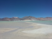 seashore with mountain during daytime
