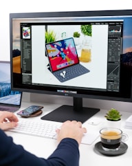 person using computer setup on white desk