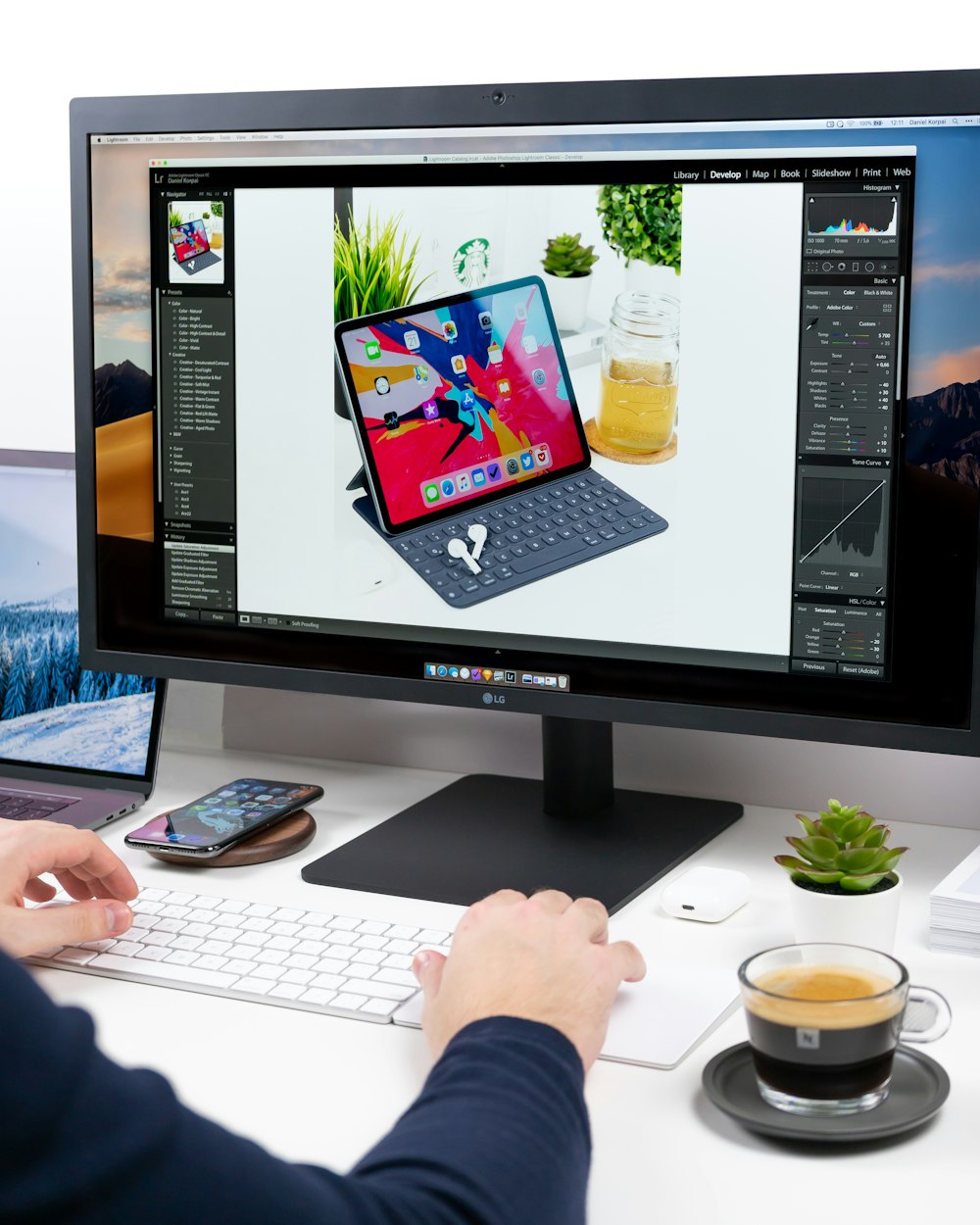 person using computer setup on white desk