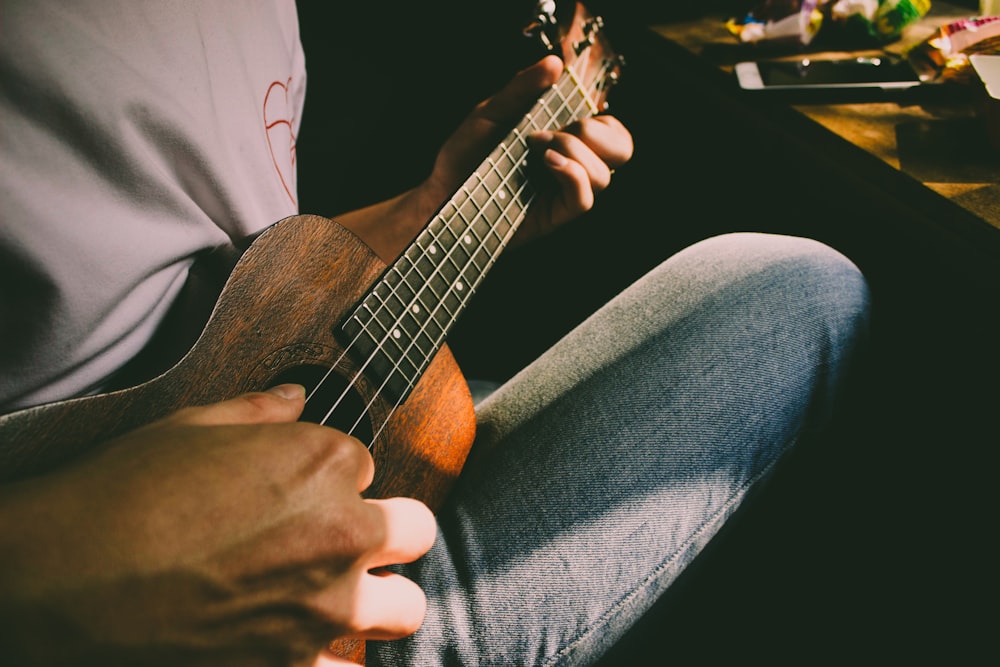 man playing Ukulele