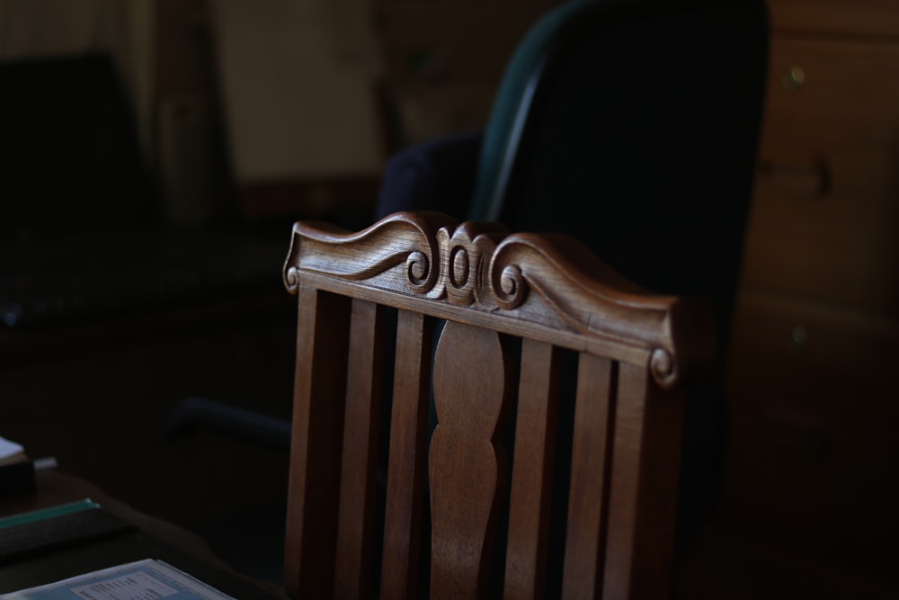 brown wooden armless chair inside room