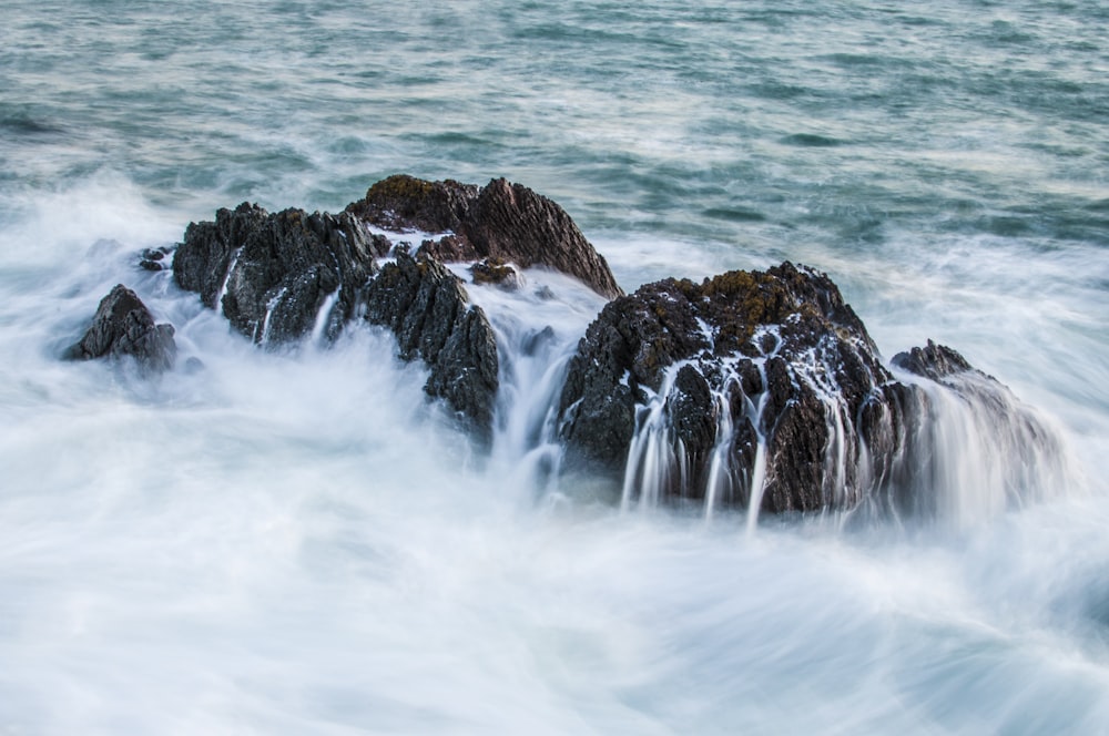 rocks on body of water during daytime