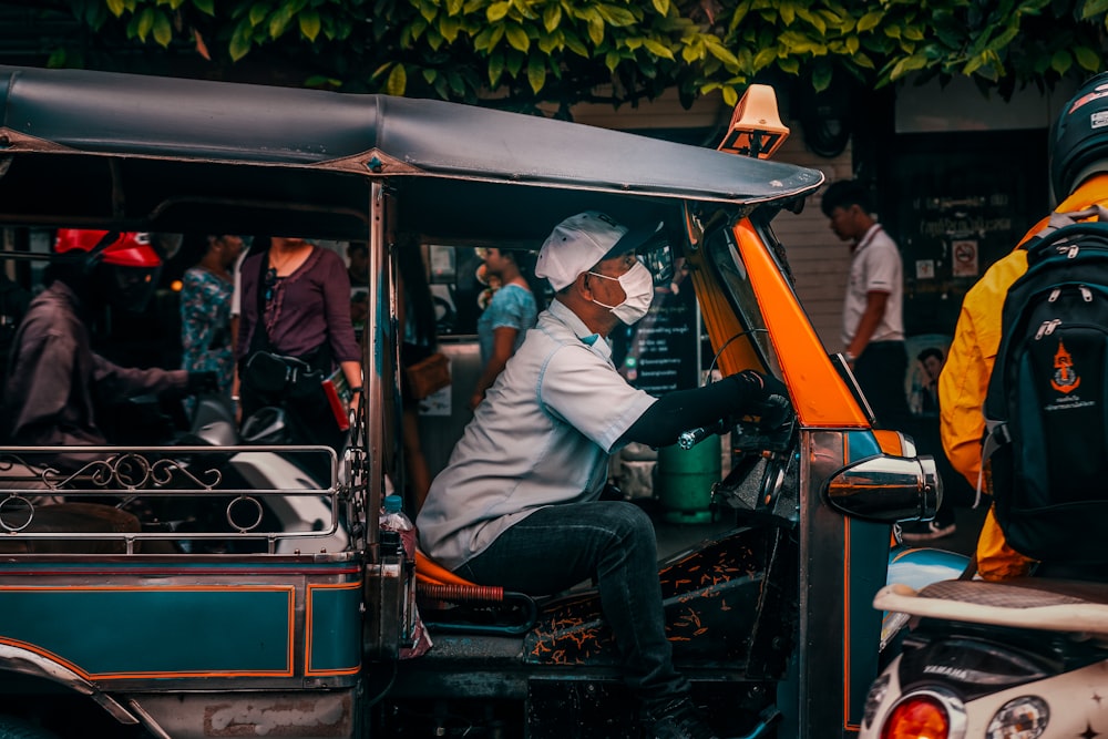 man wearing face mask riding motorcycle