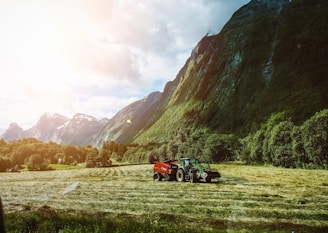 a couple of tractors are parked in a field