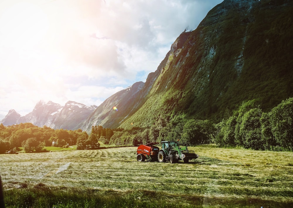 a couple of tractors are parked in a field