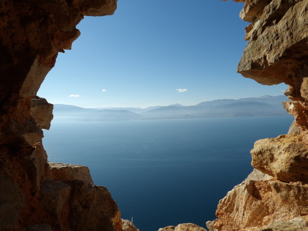 a view of a body of water from a cave