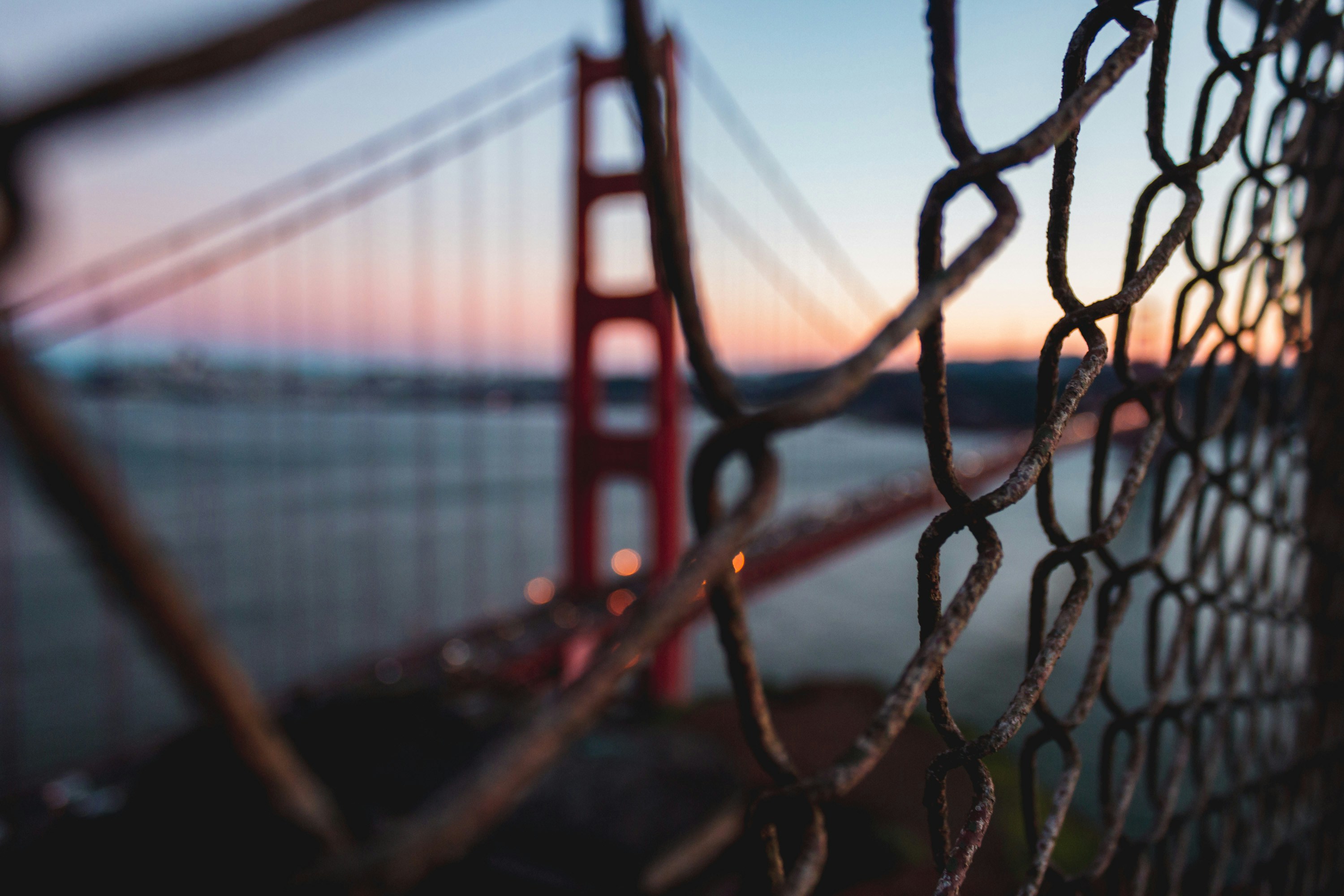Golden Gate Bridge near fence at night