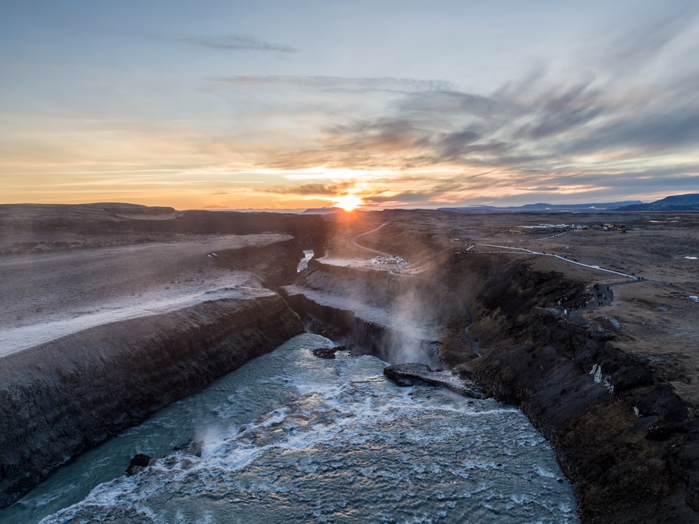 flowing body of water under gray sky