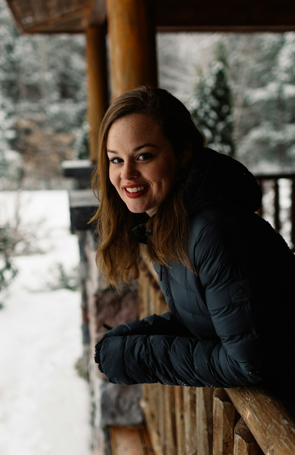 woman wearing down jacket in house selective focus photography