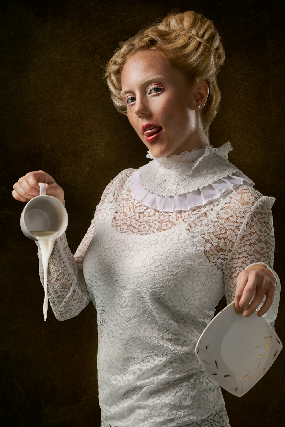 woman wearing white long-sleeved shirt holding ceramic mug